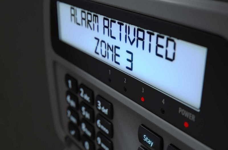 A 3D render of a home security keypad access panel with buttons and an illuminated screen displaying a break in or security breach, importance of home security systems